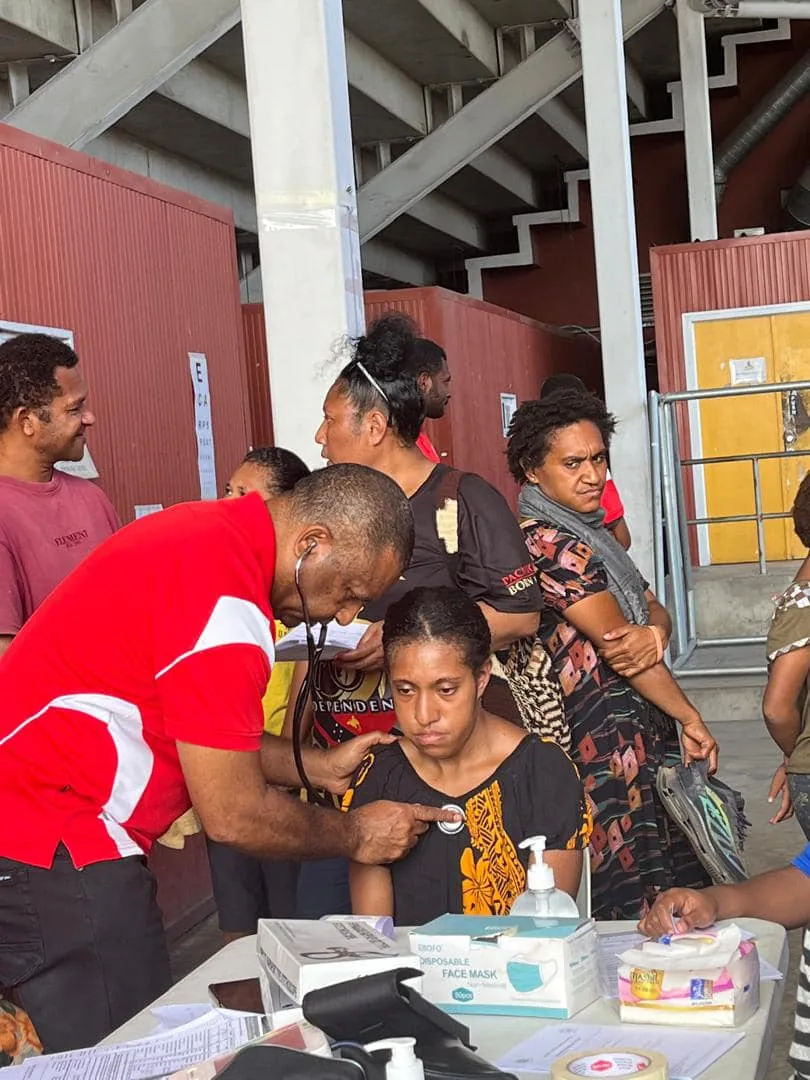 Health partners support an athlete at a community screening